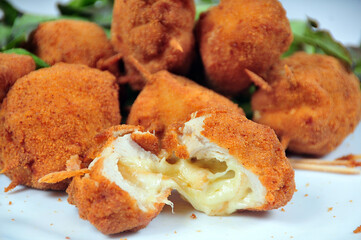 delicious fried bacalhau potato and cassava dumpling, baked and stuffed with chicken, cheese, olives and cream, kieve