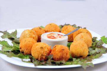 delicious fried bacalhau potato and cassava dumpling, baked and stuffed with chicken, cheese, olives and cream, kieve