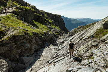 A young man walks on a stip rock formation, Vestland county, Norway