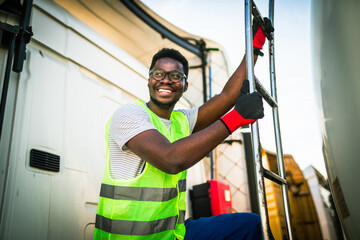 Handsome young African American man working in towing service on the road. Roadside assistance...