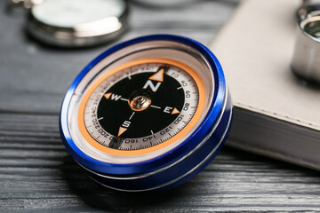 Vintage compass on dark wooden background, closeup © Pixel-Shot