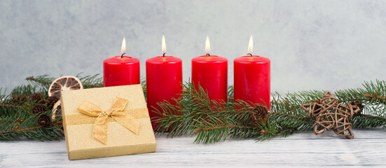 Fototapeta na wymiar Red candles on a advent wreath, christmas decoration with candlelight