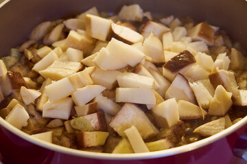 Sliced wild mushrooms in a frying pan.