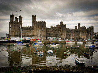 stylised Caernarfon castle with reflection over the river, circa September 2021