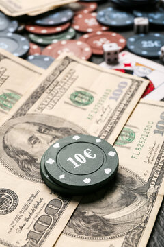 Dollar banknotes and poker chips on table, closeup