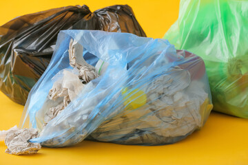 Obraz premium Bags with garbage on color background