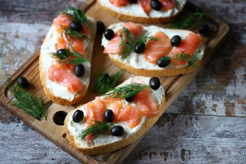 Salmon sandwich with cream cheese and olives.