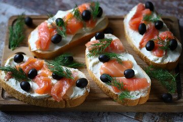 Salmon sandwich with cream cheese and olives.