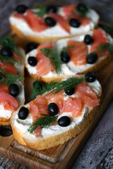 Salmon sandwich with cream cheese and olives.