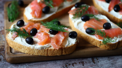 Salmon sandwich with cream cheese and olives.