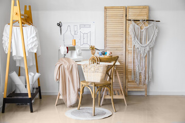 Tailor's workplace with sewing machine in modern atelier