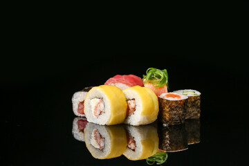 Different sushi and maki rolls on dark background © Pixel-Shot