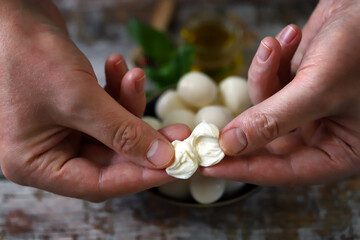 Tear the mozzarella ball with your hands. Mozzarella inside.