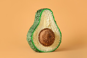 Mexican pinata in shape of avocado on color background