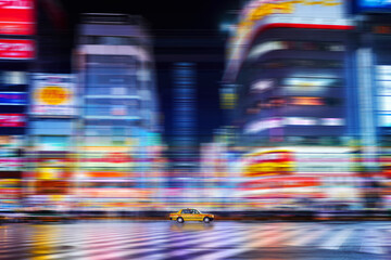 Horizontal shot of a yellow taxi in the street, fast shutter speed street photography