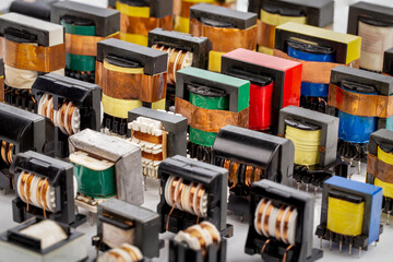 Close up of many old used inductor copper electric ferrite power transformers.