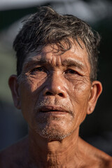 Portrait of older Asian male farmer, in rural Thailand