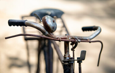 Vintage bicycle handlebar, old bicycle blur in background.