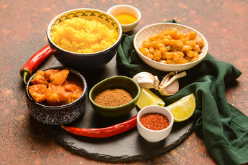 Traditional Indian food and spices on color background