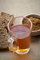 Sliced organic bread, black tea and sugar Muscovado Top view. Selective focus.