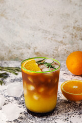 Glass of tasty coffee with orange juice on table