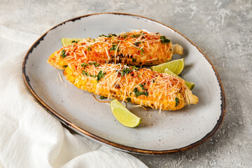 Plate with tasty Elote Mexican Street Corn on grey background