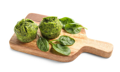 Wooden board with tasty spinach muffins on white background