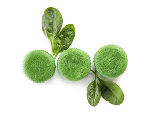Tasty spinach muffins on white background