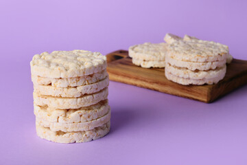 Stack of crispy rice crackers on color background
