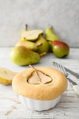 Tasty pear pot pie on light wooden background