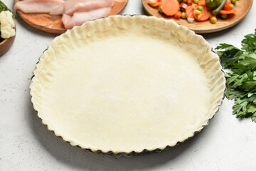 Raw dough for preparing tasty pot pie on light background, closeup
