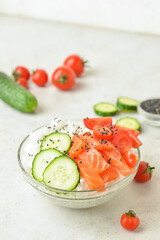 Tasty poke bowl on light background