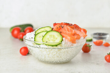 Tasty poke bowl on light background