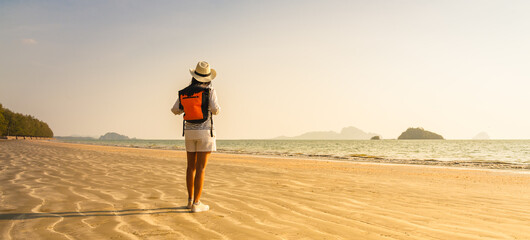 Wide panorama woman traveler on summer vacation joy scenic view sunset Pak Meng beach, Leisure...