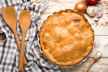Baking dish with tasty chicken pot pie on white wooden background