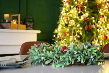Fototapeta na wymiar Table setting with Christmas decor in living room
