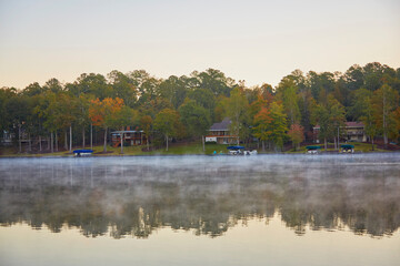 Houses on the lake shore with steam rising from the water on a southern lake in Georgia
