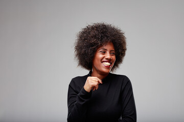 Fototapeta na wymiar Candid portrait of a giggling young Black woman