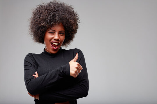 Playful Young Black Woman Winking At The Camera