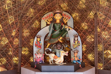 Idol of Goddess Devi Durga at a decorated puja pandal in Kolkata, West Bengal, India. Durga Puja is...