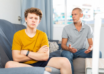 Fototapeta premium Father comforting his son who's in bad mood and feeling depressed.