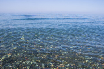 Stones in clear water of sea, water background