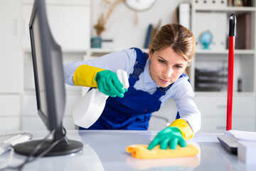 adult female cleaner with cleaning supplies washing in cabinet. High quality photo