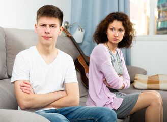 Portrait of family of mother and teenage son offended after quarrel