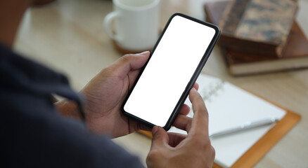 Close up view of man holding smart phone. Blank screen for your text message or information content.