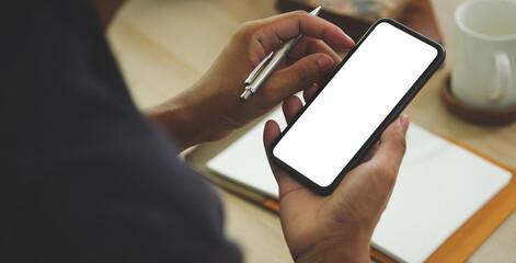 Man holding mock up smart phone. Blank screen for your text message or information content.