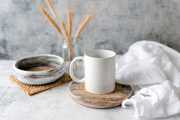 Fototapeta na wymiar Coffee mug mockup, boho or kitchen themed mug mock up, neutral tones. Concept branding mock up for logo or design.