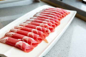 fresh raw pork belly sliced on plate in restaurant.