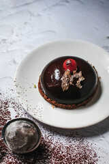 Chocolate mousse with berries and cocoa powder on a dark background. Top view. Flat lay.