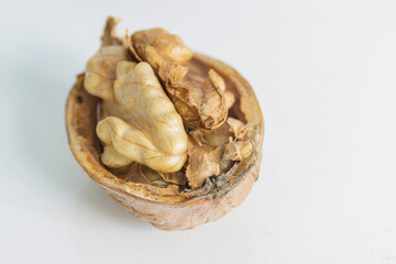  half a ripe walnut on a gray-white background close-up